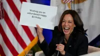 Kamala Harris holding sign
