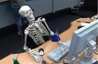 Skeleton at desk/computer/work